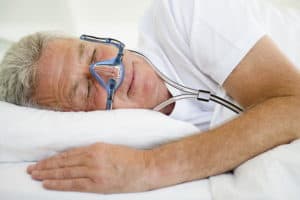 Man sleeping with CPAP mask